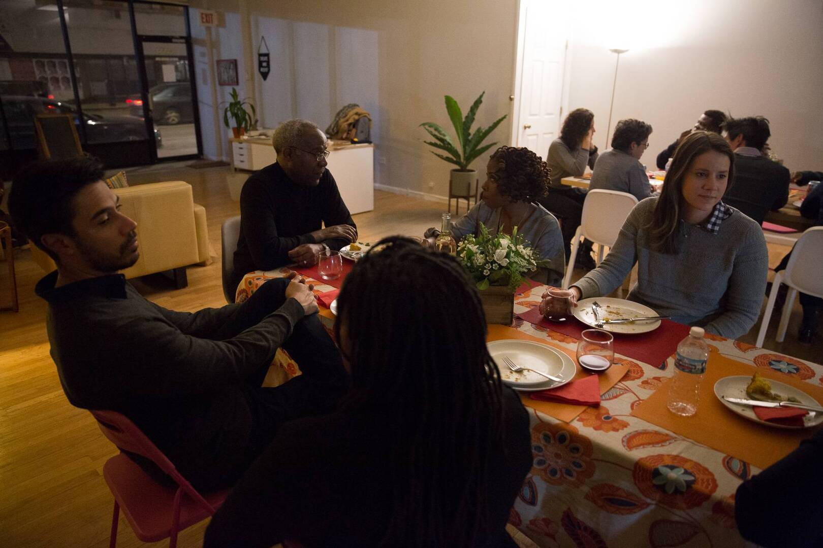 artists breaking bread and enjoying a meal together